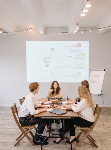 several people sitting at a table having a relaxed strategy meeting